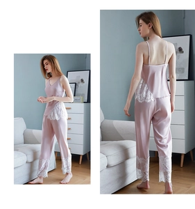 Detail of pink satin pajama set with delicate white eyelash lace on top and pants