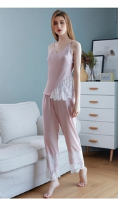 Detailed close-up of pink satin pajama set featuring delicate white floral lace trim