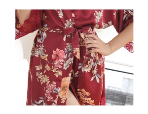 Detail of red floral satin robe featuring delicate lace trim and waist tie closure