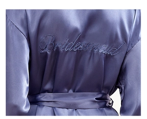 Detailed view of Bridesmaid embroidery on silky purple satin bridal robe fabric