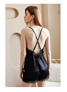 Detailed back view of black satin camisole with lace trim and crisscross straps