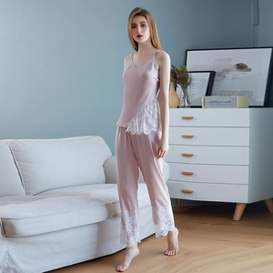 Satin sleepwear set featuring a lace trim camisole and long pants in dusty rose pink