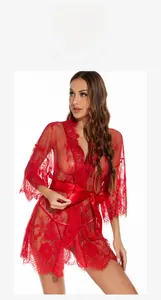 Close-up of intricate red floral lace fabric and silk waist belt on a sheer sexy robe