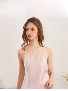Detail of light pink silk satin nightgown featuring delicate spaghetti straps and V-neck