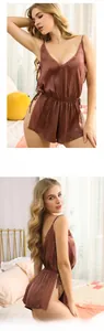 Detail view of burgundy satin romper featuring delicate lace trim and sexy side ties