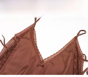 Detailed view of the lace neckline with a small bow on a silky satin bodysuit