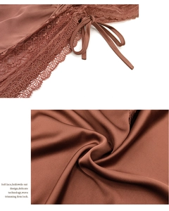 Detail of silk satin bodysuit featuring delicate lace trim and adjustable drawstring ties