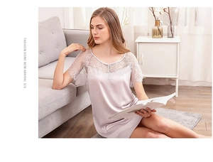 Détails de dentelle florale sur une chemise de nuit rose satinée au tissu fluide