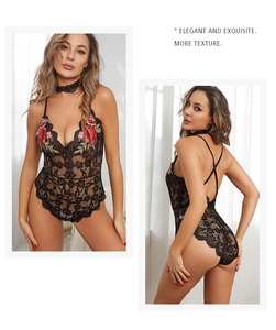 Détail d'un body en dentelle noire avec broderie de roses rouges et dos nu croisé