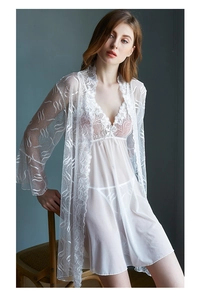 Detailed view of white floral lace robe and sheer mesh nightgown set on a model