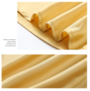 Detailed macro view of yellow satin fabric showing wave trimming and firm lock stitching