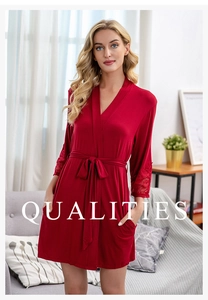 Detail of red modal bathrobe featuring delicate lace trim on sleeves and a waist tie