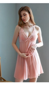 Close-up of pink lace negligee with floral embroidery and delicate bow detailing
