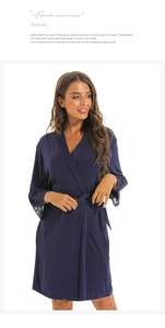 Detailed view of the dark blue modal robe featuring delicate lace trim on the cuffs