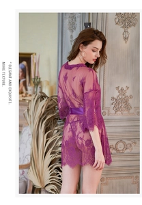 Close-up of purple floral lace texture and eyelash fringe on the sleeve of this robe