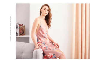 Detailed back view of pink satin long slip dress with large floral patterns and thin straps