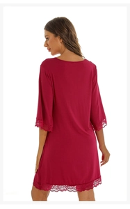 Detail of delicate lace trim on the cuffs and hem of this burgundy modal cotton nightdress