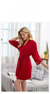 Detail of red modal bathrobe featuring delicate lace trim on the sleeves and waist belt