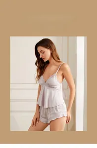 Detail view of lavender silk satin pajamas with delicate lace trim on camisole and shorts
