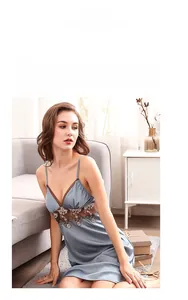 Detail of grey-blue satin nightdress with delicate brown lace embroidery and V-neckline