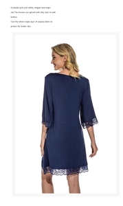 Close-up of dark blue nightdress featuring delicate lace hem and silky modal fabric