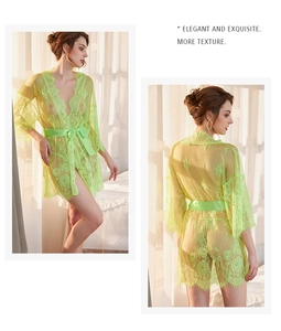 Detailed view of floral lace embroidery and satin waist tie on emerald green robe