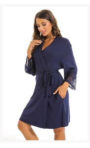 Detail of delicate lace trim on sleeves of navy blue modal bathrobe for women