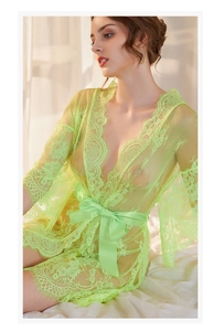Close-up of fluorescent green lace mesh robe with eyelash trim and satin ribbon tie
