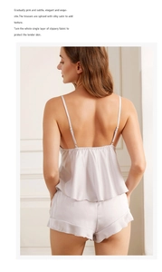 Detail of light pink satin pajama set featuring ruffled shorts and pleated back design