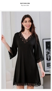 Detail of delicate black floral lace on V-neck modal cotton nightgown with bell sleeves