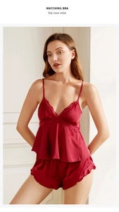 Close-up of dry rose silk pajamas set with lace neckline and ruffled hem shorts