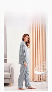 Detail of H-line ice silk pajama set showing smooth satin texture and white contrast piping