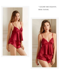Detailed view of burgundy satin pajama set with delicate lace trim and ruffled hem shorts