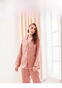Detail of contrast color pocket and white piping on silk-like satin pajama top