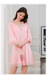 Close-up of pink modal nightgown with lace V-neckline and delicate floral embroidery
