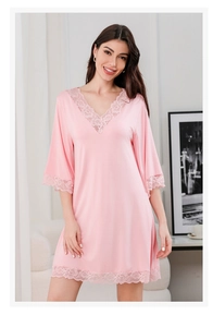 Detailed close-up of lace-trimmed V-neckline on soft modal cotton pink nightgown