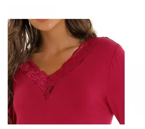 Close-up of elegant V-neckline with delicate burgundy lace trim on modal nightdress