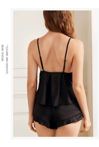 Detail view of black satin pajama set with elegant ruffled layers on the back