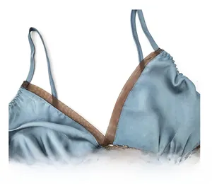 Detail of grey-blue silk satin slip dress with lace trim and elegant V-neckline embroidery