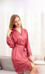 Detail of elegant satin bathrobe with delicate lace trim on sleeves and hemline