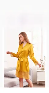 Detail of yellow ice silk robe with lace trim on sleeves and hem in home setting