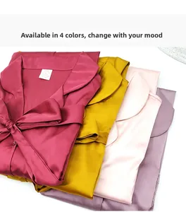 Close-up of folded silk satin robes in burgundy, yellow, pink, and lilac with smooth texture