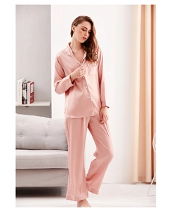 Detailed view of women's silk pajama set with contrast piping and smooth satin texture