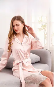 Detailed view of pink silk bathrobe with white lace trim and elegant bow waist belt