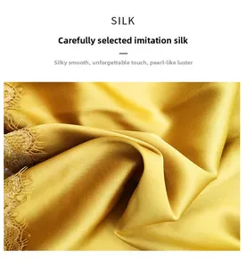 Detailed view of bright gold silk satin fabric with elegant lace trim texture