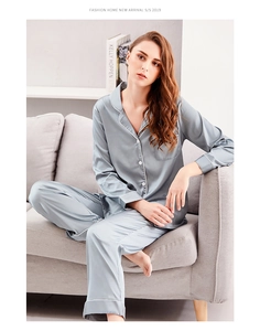 Close-up of gray-blue silk pajamas set featuring contrast piping and elegant pearl luster