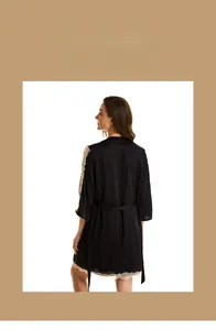 Detail of black silk nightdress featuring exquisite gold floral lace on sleeves and hem