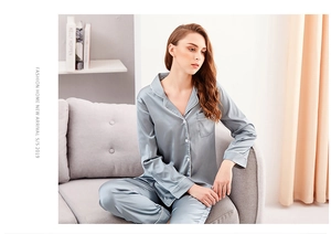 Detailed view of silver grey satin pajama set with contrast piping on sleeve and pocket