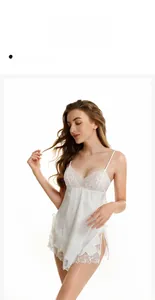 Detailed close-up of white silk sleepwear with floral lace embroidery and high side slit