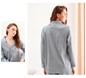 Detail of silver silk satin pajama set featuring classic lapel with white piping